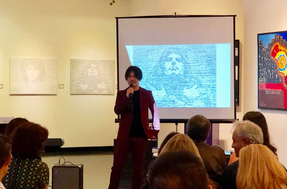 Artist Hayato Takano explaining to guest how he creates his unique masterpiece.